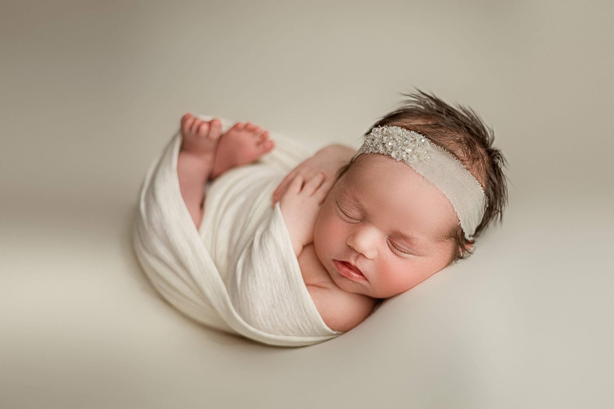 Adorable newborn baby wrapped beautifully in taco pose