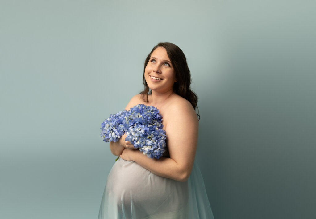 Joyful maternity portrait of an expecting mother in Maple Grove studio, part of a combined maternity and newborn photography package for families near Excelsior, Waconia, and Eden Prairie.